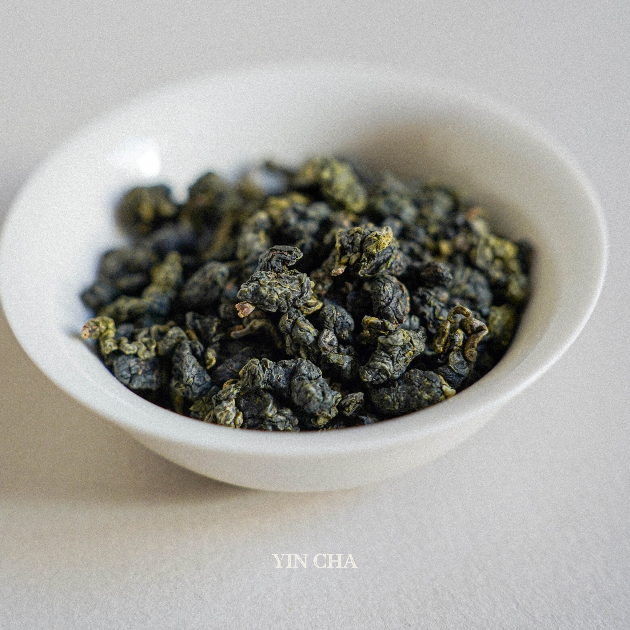 milky oolong dry tea leaves in the small white plate