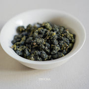 milky oolong dry tea leaves in the small white plate