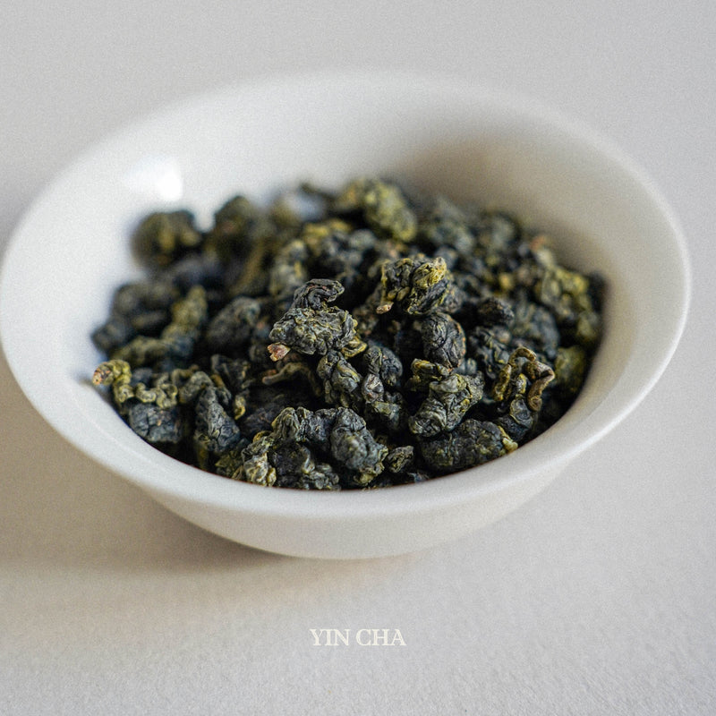 milky oolong dry tea leaves in the small white plate